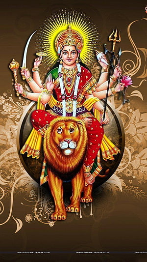 Maa Durga riding a lion with multiple arms holding weapons and a radiant golden halo HD phone wallpaper