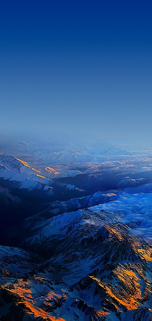 Snow-Capped Alpine Peaks at Golden Hour with Sea of Clouds and Deep Blue Sky HD phone wallpaper