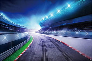 Illuminated Nighttime Racetrack With Curved Asphalt And Stadium Lights HD wallpaper