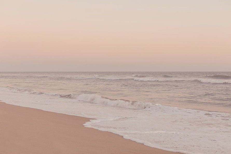 Soft Pink Beach at Dusk with Gentle Waves and Minimalist Ocean Horizon HD wallpaper