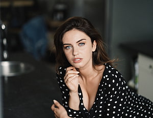 Elegant Portrait of a Woman in a Black Polka Dot Blouse with Blue Eyes HD wallpaper
