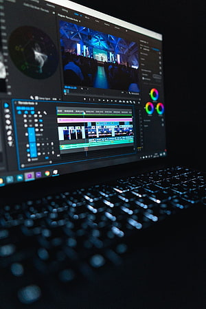 Adobe Premiere Pro Video Editing Timeline on Backlit Laptop Keyboard in Dark Studio HD phone wallpaper