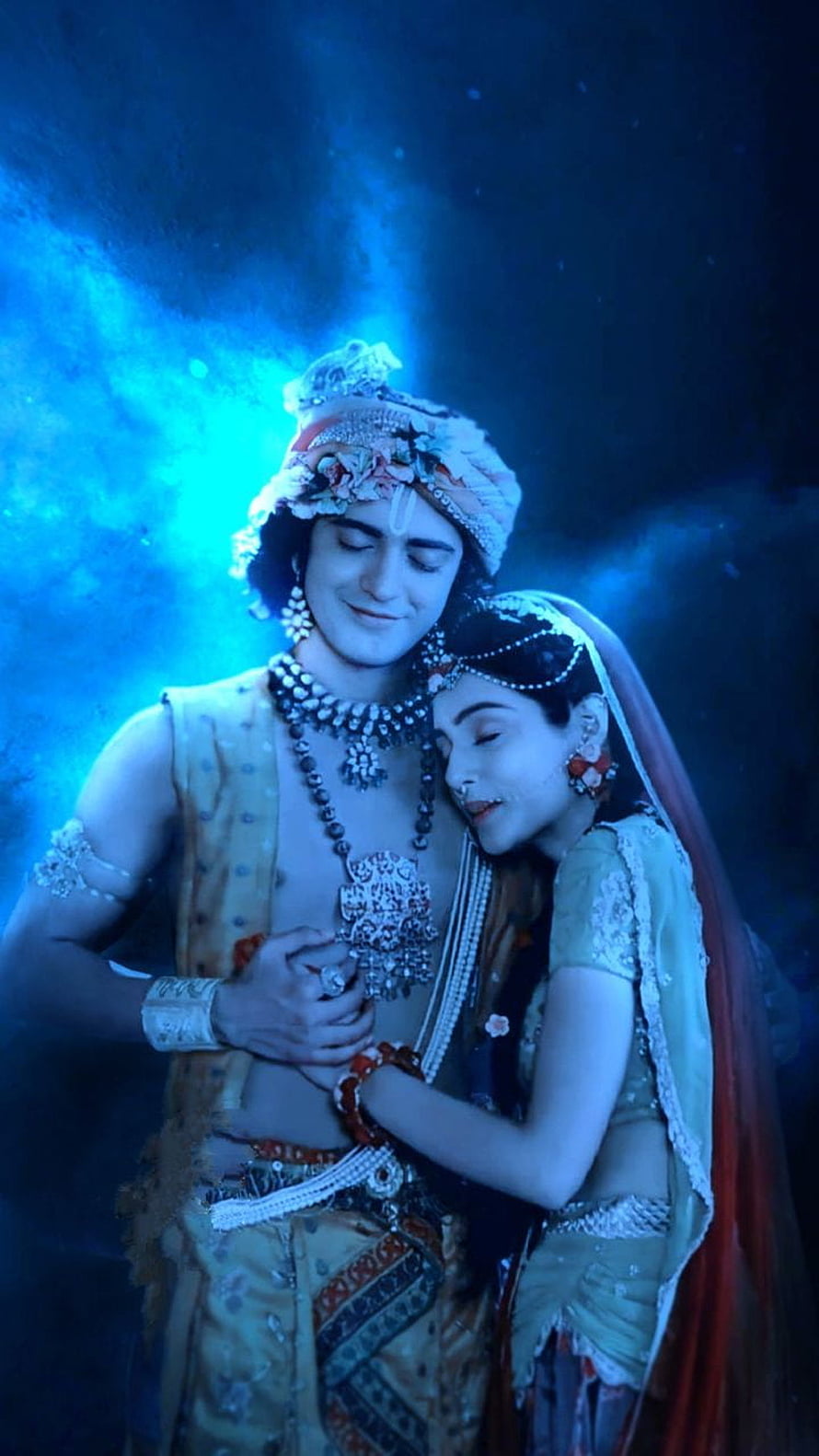 Radha Krishna Divine Embrace in Traditional Indian Attire with Blue Lighting HD phone wallpaper