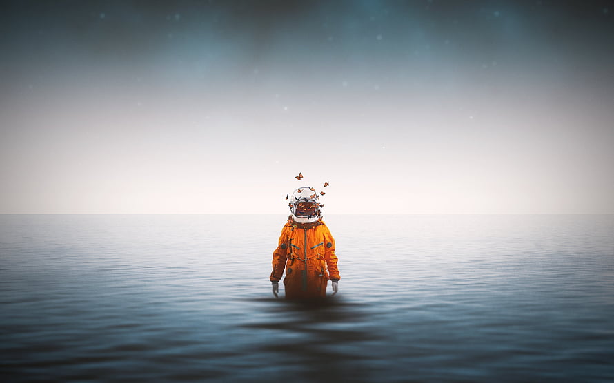 Lone Astronaut in Orange Suit Standing in Calm Ocean with Butterflies HD wallpaper