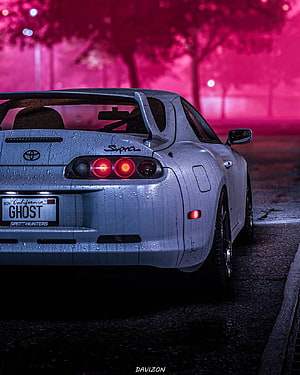 Rear View of a Silver Toyota Supra MK4 Parked on a Wet Street Under Neon Pink Lighting HD phone wallpaper