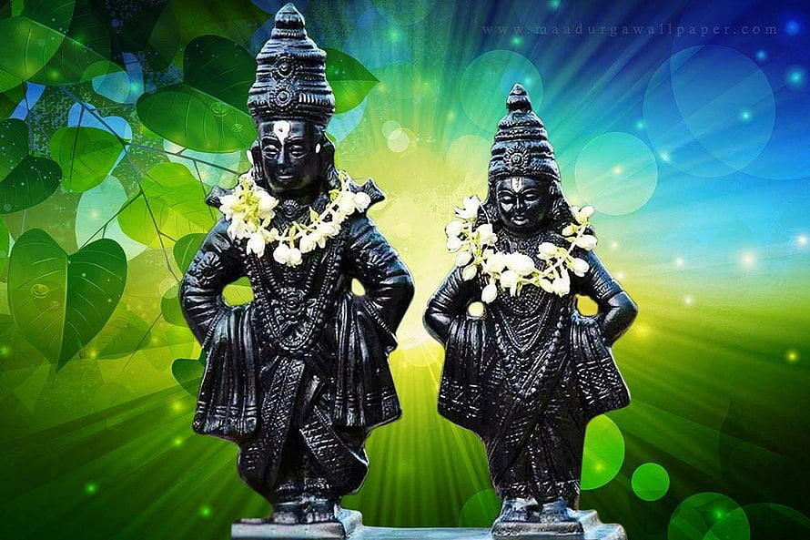 Black Stone Idols of Vitthal and Rukmini Adorned with White Flower Garlands HD wallpaper