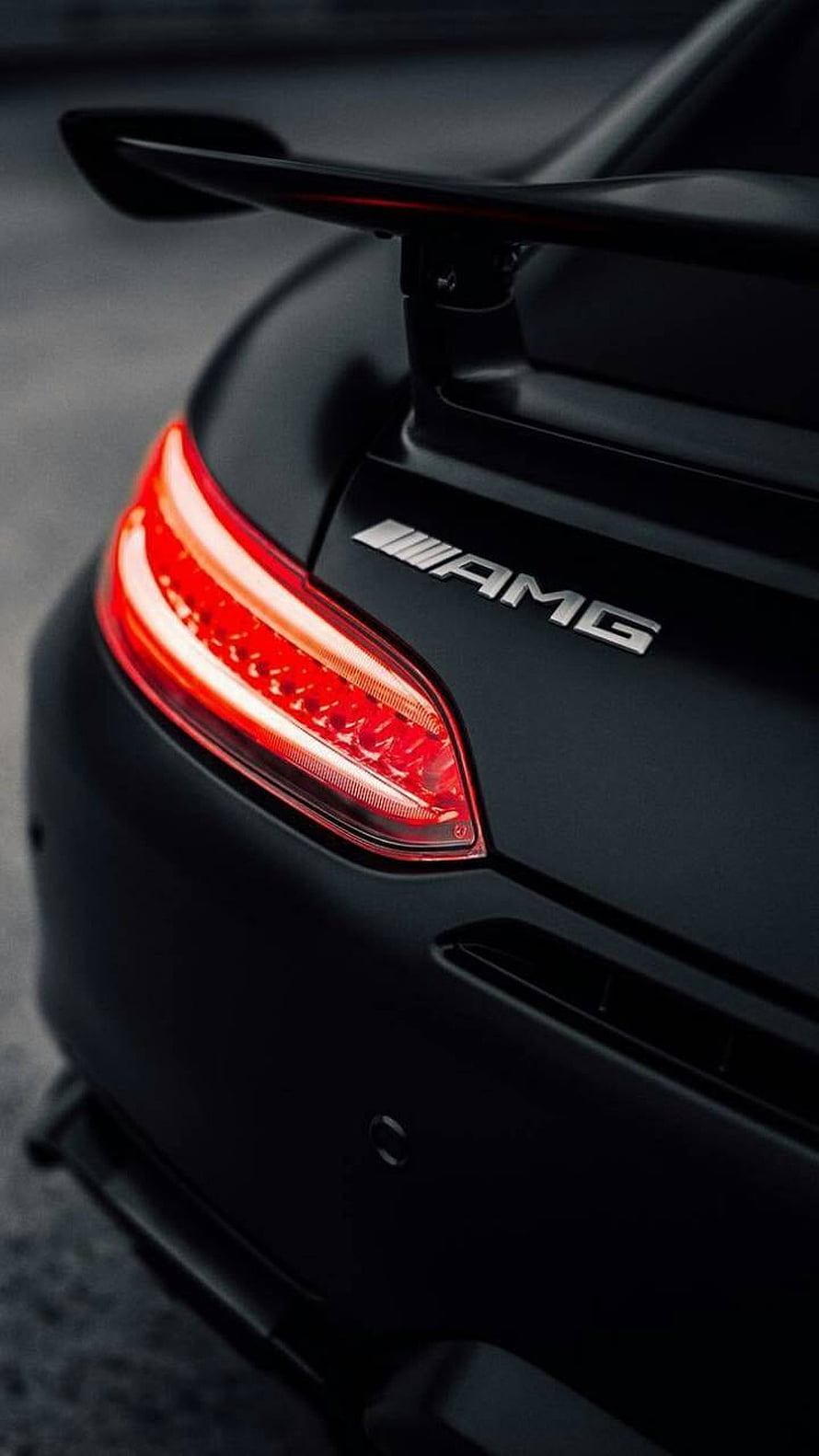 Mercedes AMG Rear Spoiler and Taillight Detail on Matte Black Performance Car HD phone wallpaper