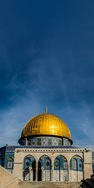Dome of the Rock in Jerusalem with golden dome and intricate Islamic tilework against a clear blue sky HD phone wallpaper