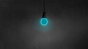 Glowing Cyan LED Light Bulb Hanging Against a Dark Minimalist Background HD wallpaper