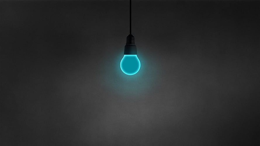 Glowing Cyan LED Light Bulb Hanging Against a Dark Minimalist Background HD wallpaper