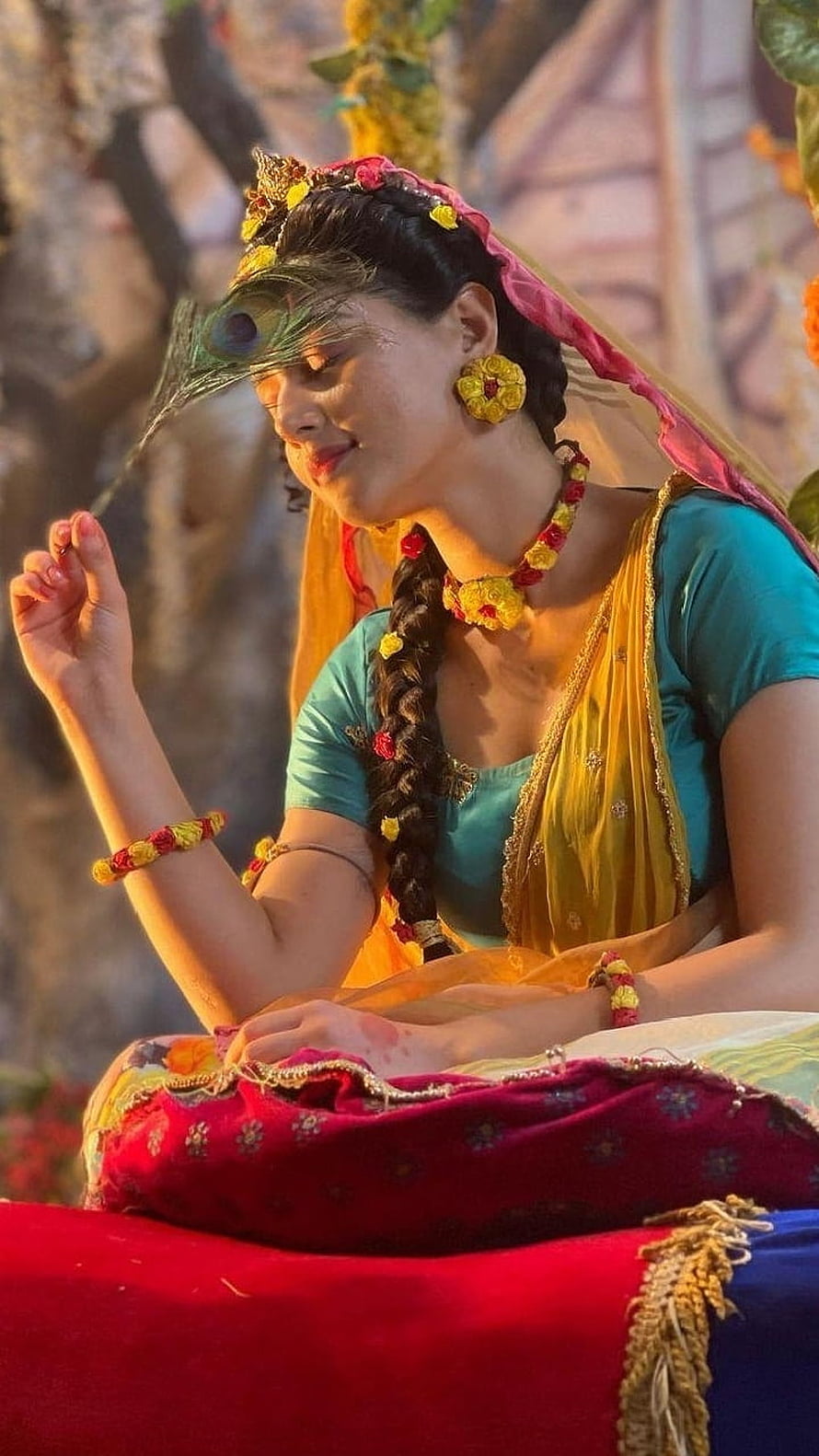 Mallika Singh in Traditional Indian Attire with Floral Jewelry and Peacock Feather HD phone wallpaper
