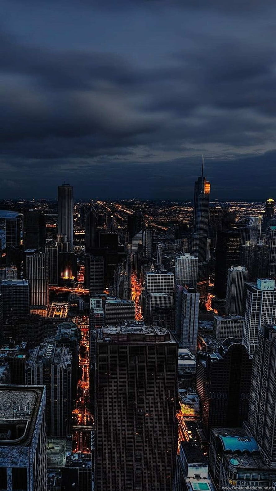 Dramatic Twilight Skyline of a Dense Urban Metropolis with Glowing Street Lights HD phone wallpaper