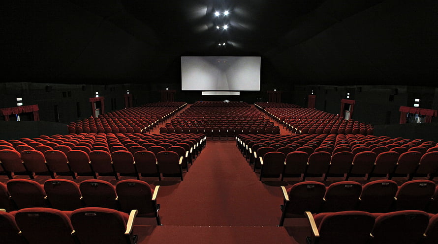 Empty Movie Theater Interior With Rows of Red Seats and Large Projection Screen HD wallpaper