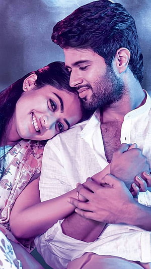 Rashmika Mandanna and Vijay Devarakonda in an intimate romantic embrace with soft purple lighting HD phone wallpaper