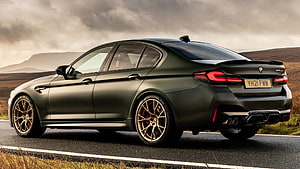 BMW M5 CS Matte Green Sedan on a Scenic Mountain Road HD wallpaper