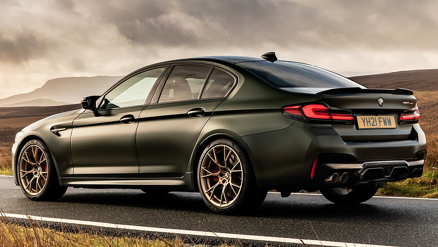 BMW M5 CS Matte Green Sedan on a Scenic Mountain Road HD wallpaper