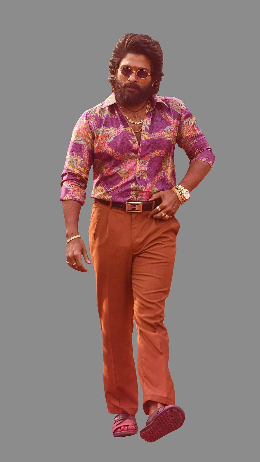 Allu Arjun as Pushpa in vibrant floral shirt and rust trousers with gold accessories HD phone wallpaper