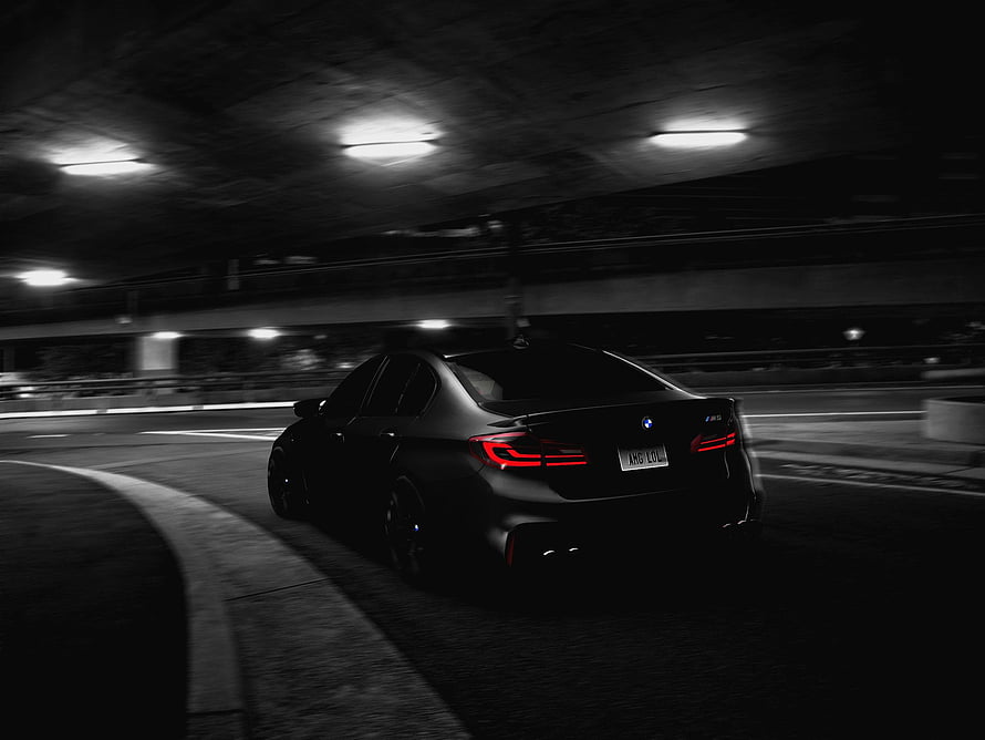 Black BMW M5 F90 Sedan Cruising Through a Dark Underpass at Night HD wallpaper