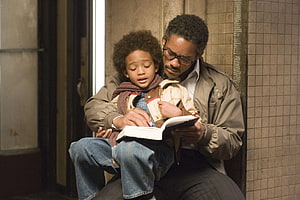 The Pursuit of Happyness: Father and Son Reading Together in a Quiet Moment HD wallpaper