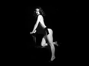 Black and White Studio Portrait of a Woman in a Sequined Dress Posing on a Chair HD wallpaper
