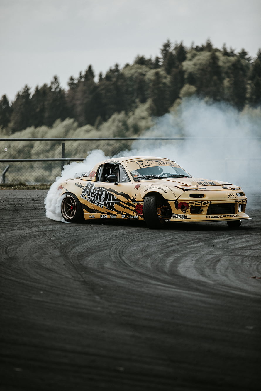 Gold Mazda RX-7 Drift Car Performing Burnout on Asphalt Track HD phone wallpaper