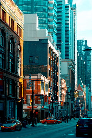 Urban Street Scene with Historic Brick Buildings and Modern Glass Skyscrapers at Dusk HD phone wallpaper