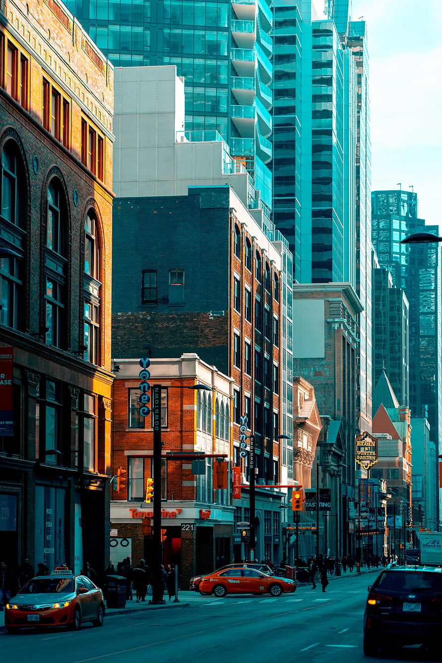 Urban Street Scene with Historic Brick Buildings and Modern Glass Skyscrapers at Dusk HD phone wallpaper