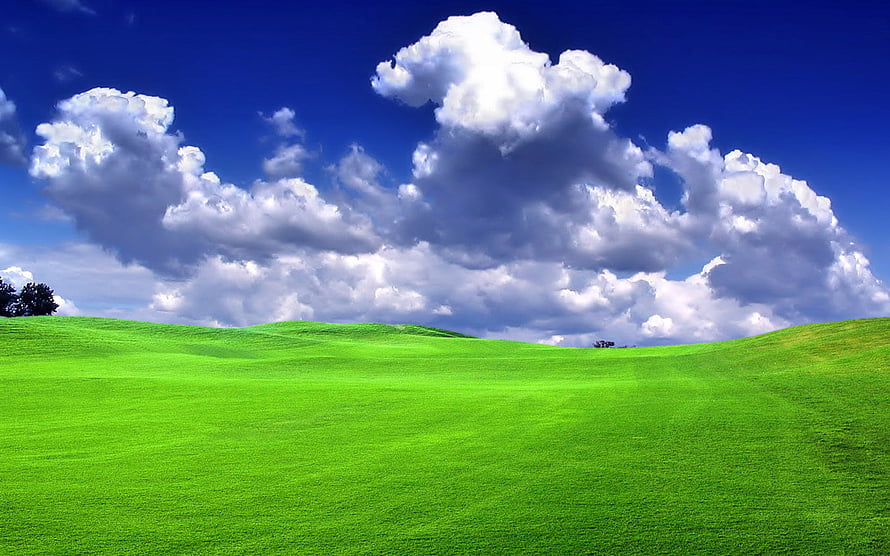Vibrant Green Rolling Hills Under a Deep Blue Sky with Fluffy White Clouds HD wallpaper
