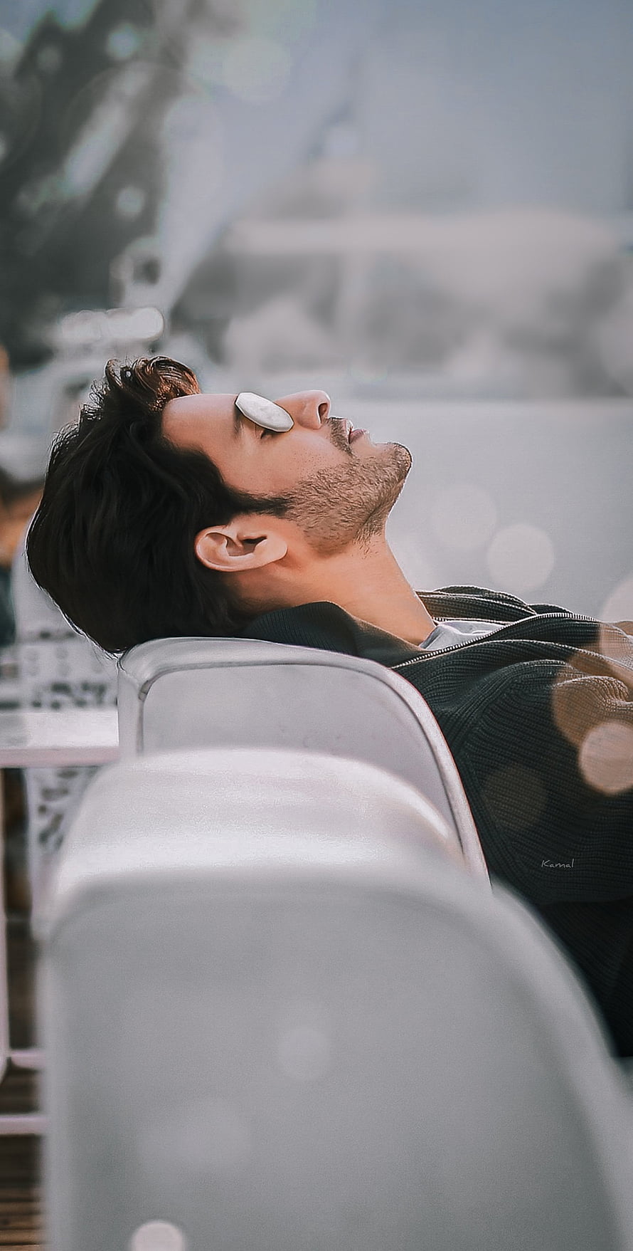 Mahesh Babu Reclining in a Chair with a Coin on His Eye in a Cinematic Scene HD phone wallpaper