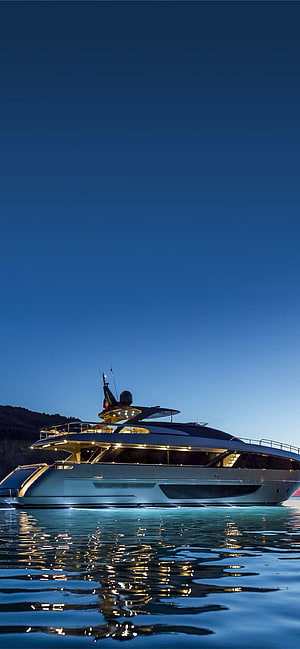 Luxury Superyacht at Dusk with Warm Deck Lighting and Water Reflections HD phone wallpaper