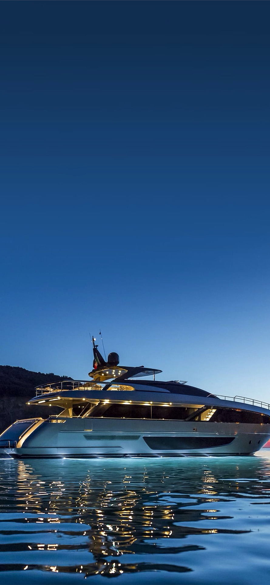 Luxury Superyacht at Dusk with Warm Deck Lighting and Water Reflections HD phone wallpaper