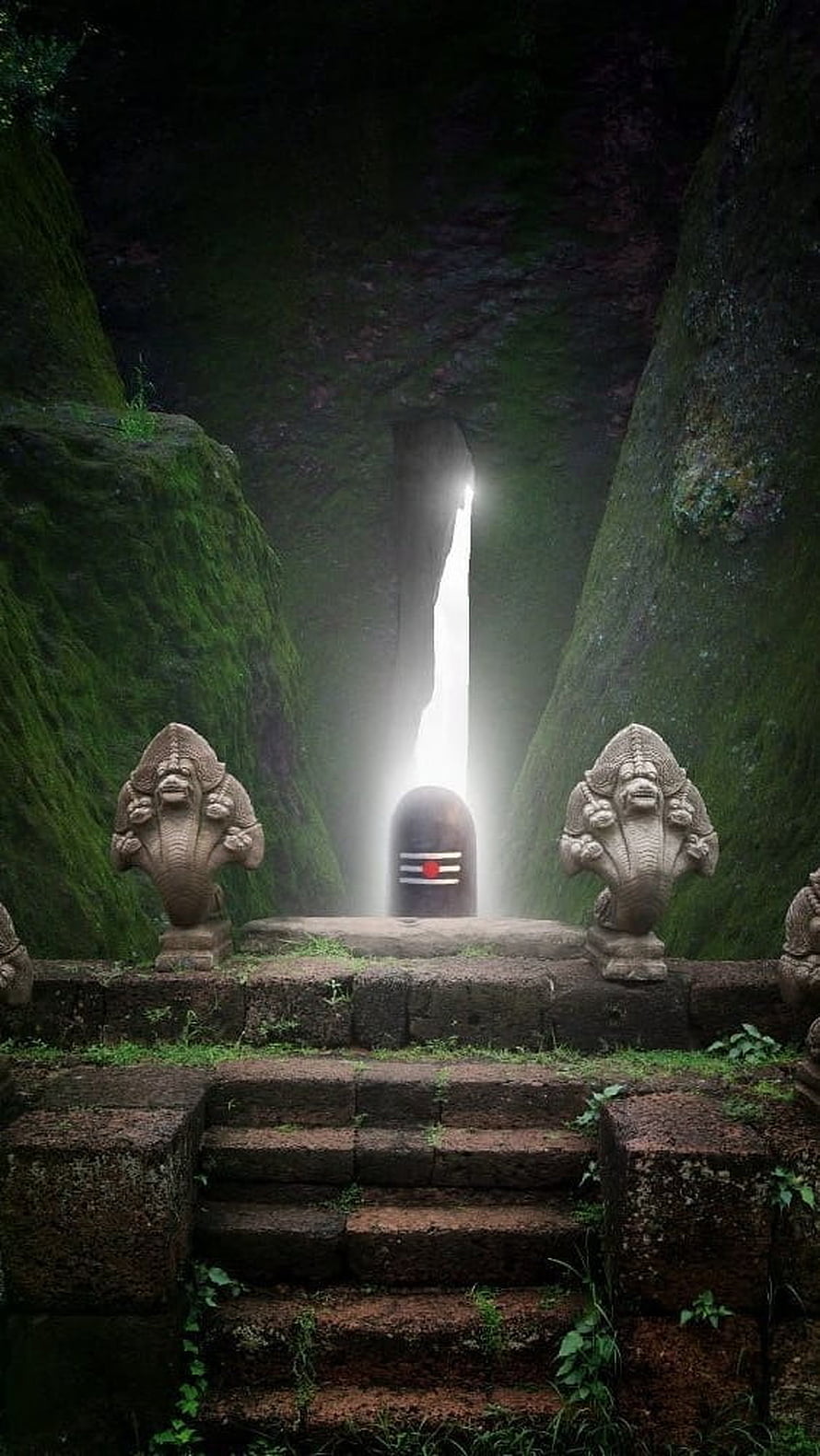 Ancient Shiv Ling Shrine in Mossy Cavern with Guardian Statues and Divine Light Beam HD phone wallpaper