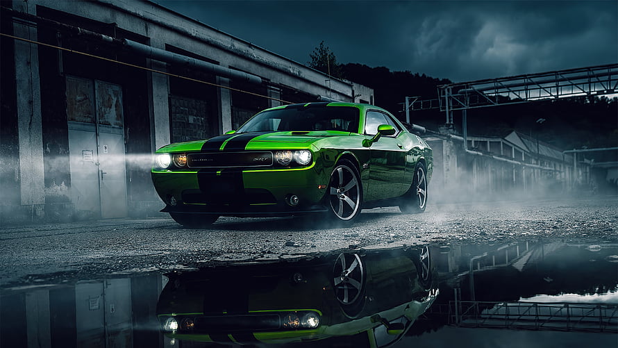 Green Dodge Challenger SRT muscle car parked in an industrial yard with dramatic storm lighting and wet ground reflections HD wallpaper