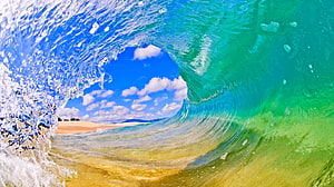 Inside a Turquoise Ocean Wave Barrel with Sandy Beach and Blue Sky HD wallpaper