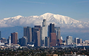 Los Angeles Downtown Skyline Framed by Snow-Capped San Gabriel Mountains HD wallpaper