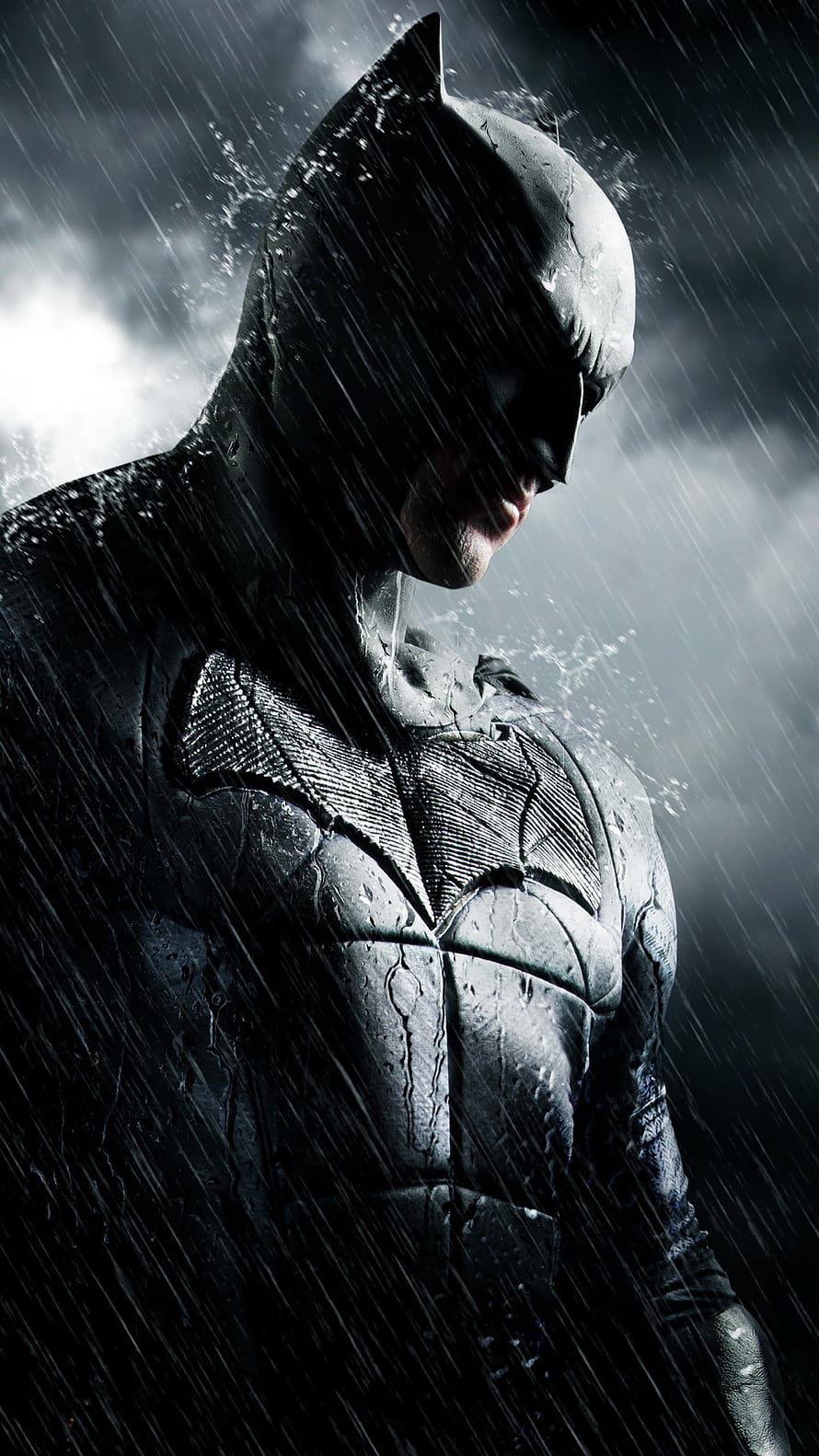 Batman in Heavy Rainstorm Wearing Dark Armored Suit with Dramatic Lighting HD phone wallpaper