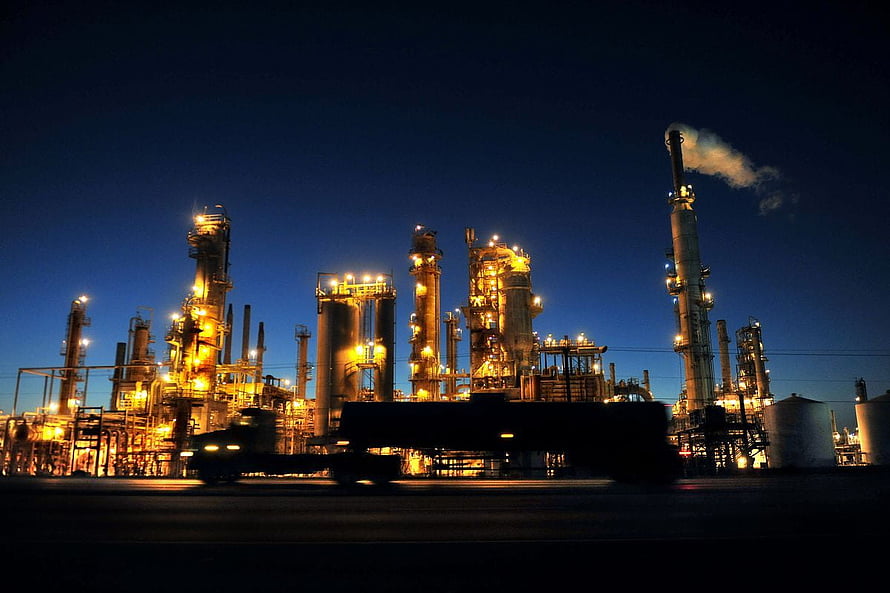 Illuminated Oil Refinery Complex at Night with Glowing Industrial Towers HD wallpaper