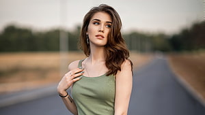 Young woman in olive tank top standing on a rural road with soft natural lighting, Girl model, pretty and brunette, gorgeous HD wallpaper