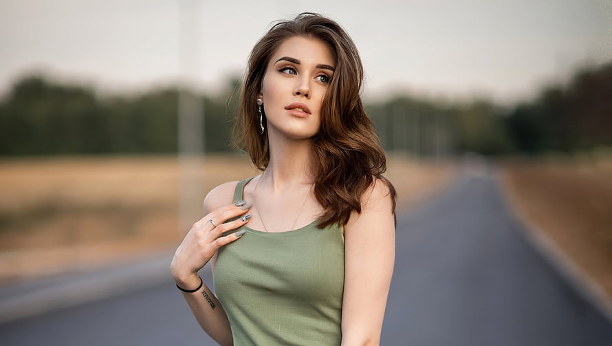 Young woman in olive tank top standing on a rural road with soft natural lighting, Girl model, pretty and brunette, gorgeous HD wallpaper