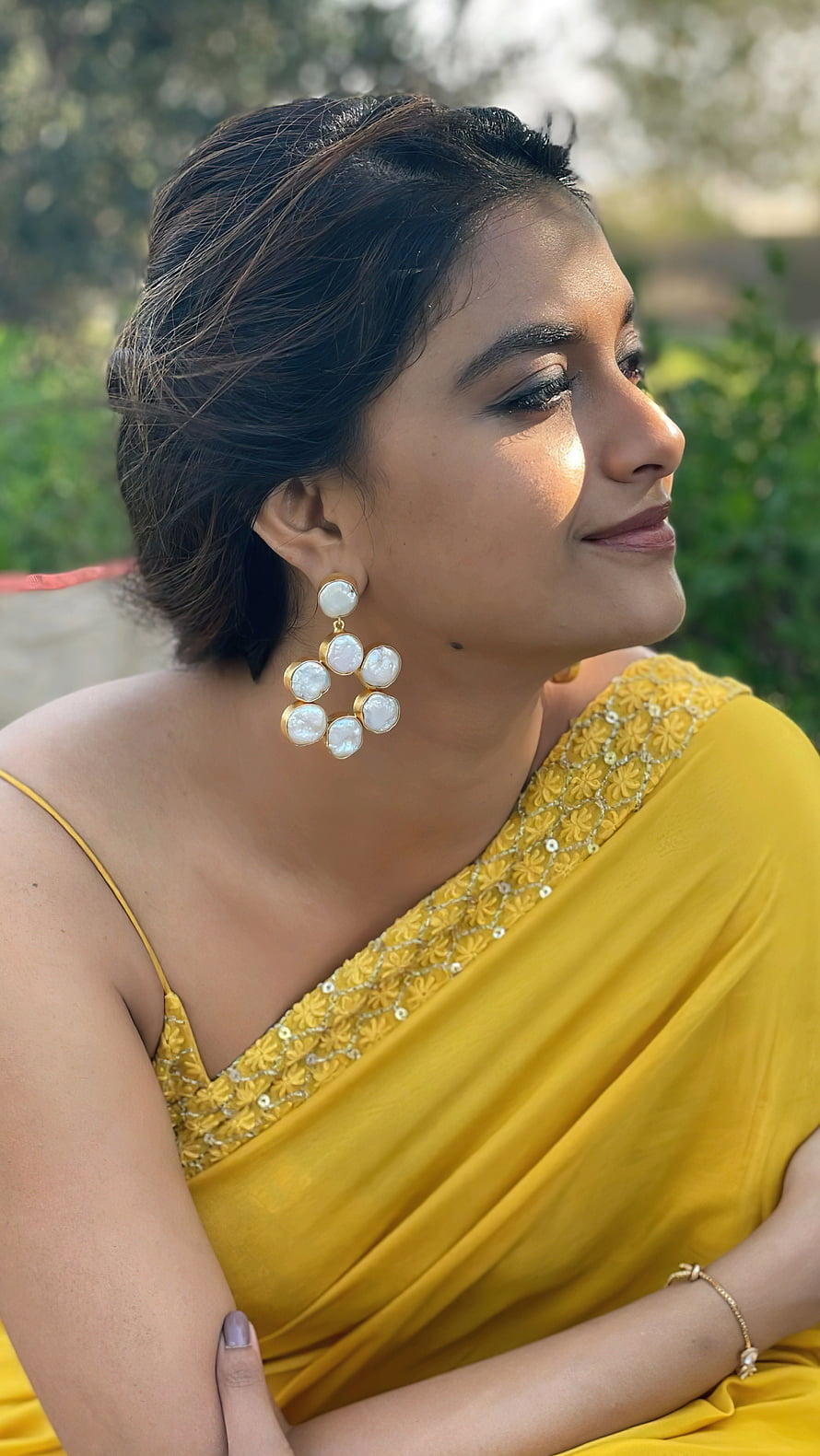 Keerthi Suresh in a vibrant yellow saree with pearl drop earrings and elegant updo hairstyle HD phone wallpaper