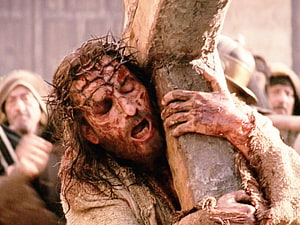 Jesus Christ Carrying the Cross in a Dramatic Cinematic Scene HD wallpaper