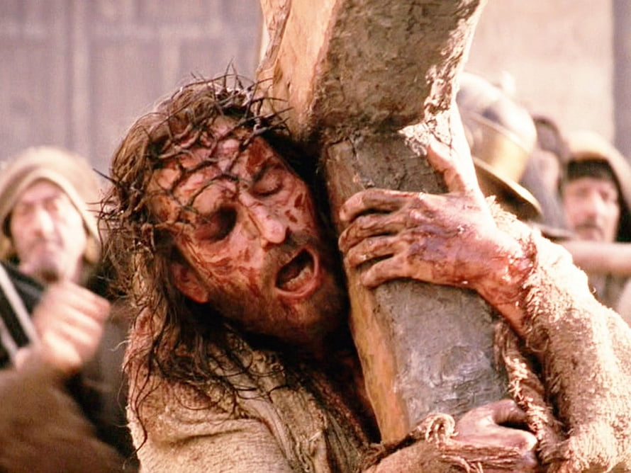Jesus Christ Carrying the Cross in a Dramatic Cinematic Scene HD wallpaper