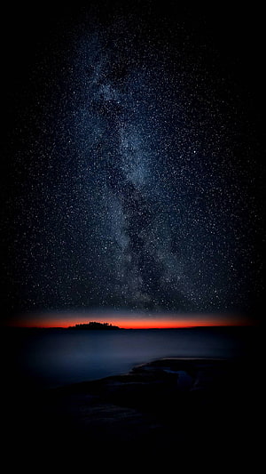 Milky Way Galaxy Rising Over Misty Lake at Night with Red Horizon Glow HD phone wallpaper