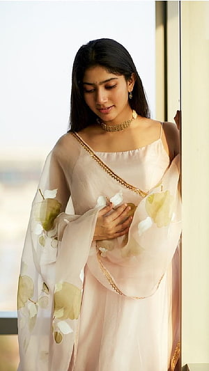 Sai Pallavi in a soft pastel floral saree with gold trim and delicate jewelry HD phone wallpaper