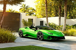 Vibrant Green Lamborghini Huracan Spyder Parked in Tropical Garden Setting HD wallpaper