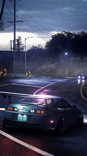 Toyota Supra MK4 drifting on a rain-soaked road at night with glowing taillights and a large rear wing HD phone wallpaper