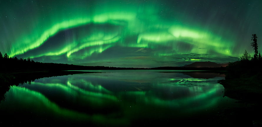 Vivid Green Aurora Borealis Reflecting on a Calm Lake in Alaska HD wallpaper