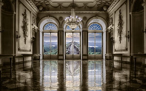 Grand Baroque Palace Hall with Crystal Chandelier and Mountain View Through Arched Windows HD wallpaper