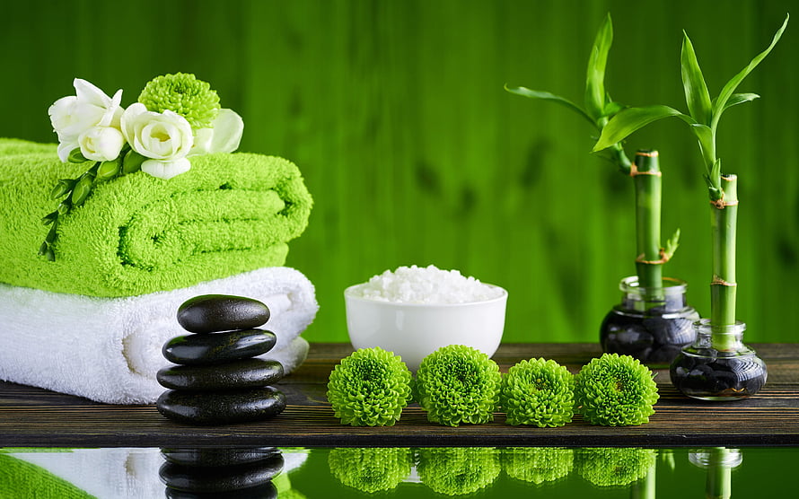 Serene Spa Still Life With Green Towels, Black Stones, Bamboo, and Fresh Flowers HD wallpaper