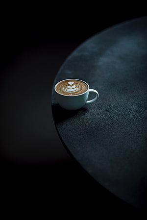 Minimalist Latte Art Cup on Dark Stone Table with Dramatic Shadow HD phone wallpaper